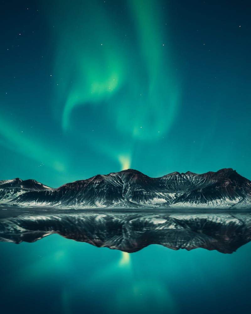 Iceland aurora borealis over mountains